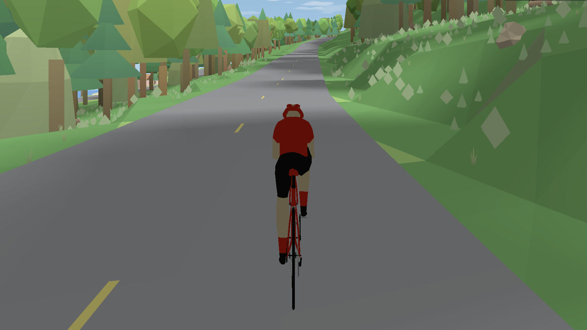 A rider in a red jersey on an empty forest road in Vive Velo, evergreens and boulder-studded hillside on both sides and a lake just visible through the trees.